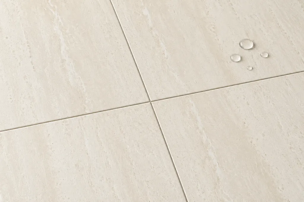 Water beading on Cava Veins Beige travertine effect porcelain, 30 x 60 cm structured matt, with no sealer applied