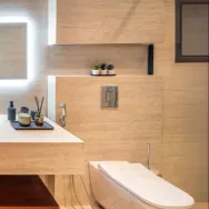 Ascoli Beige 40 × 90 cm Matt porcelain tile, bathroom with a bath and lit niche