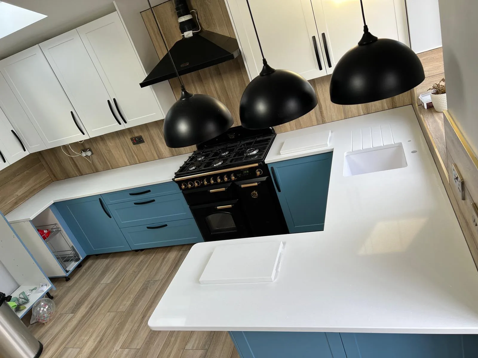 Marvra worktop installation: plain white worktop, blue and cream units